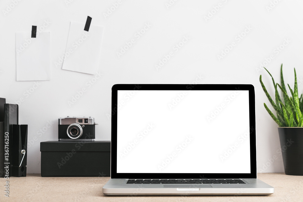 Close up of blank white laptop screen and camera on desktop. Close up of blank white laptop screen and camera on desktop.