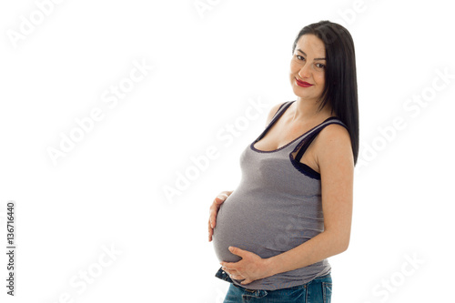 young pregnant brunette woman with big belly posing isolated on white background
