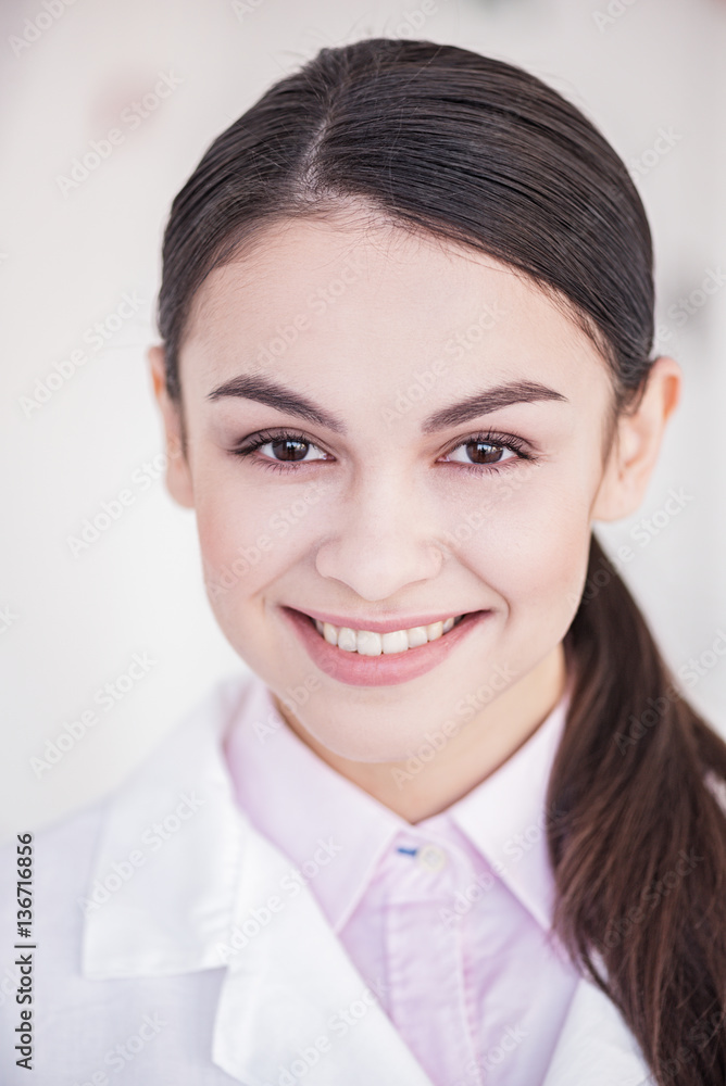 Smiling therapeutic situating in room of clinic Smiling therapeutic situating in room of clinic
