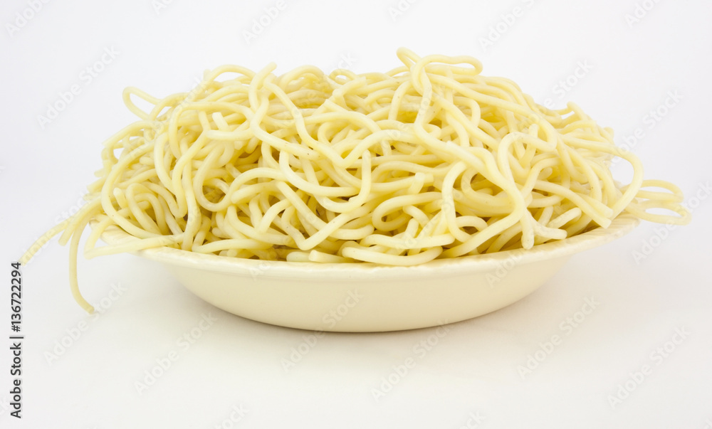 Spaghetti pasta in a white bowl. No sauce. White background. Spaghetti pasta in a white bowl. No sauce. White background.