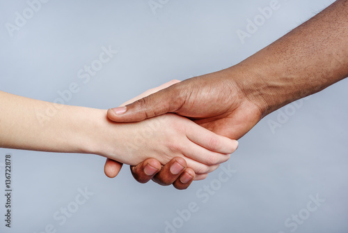 Friendly handshake by people of different ethnicity