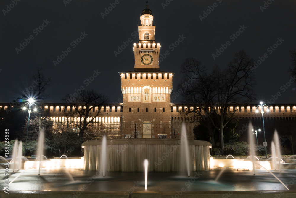Night view of the Fountain in front of the entrance to the Castle Sforzesco near Parco Sempione in center of Milan, Italy