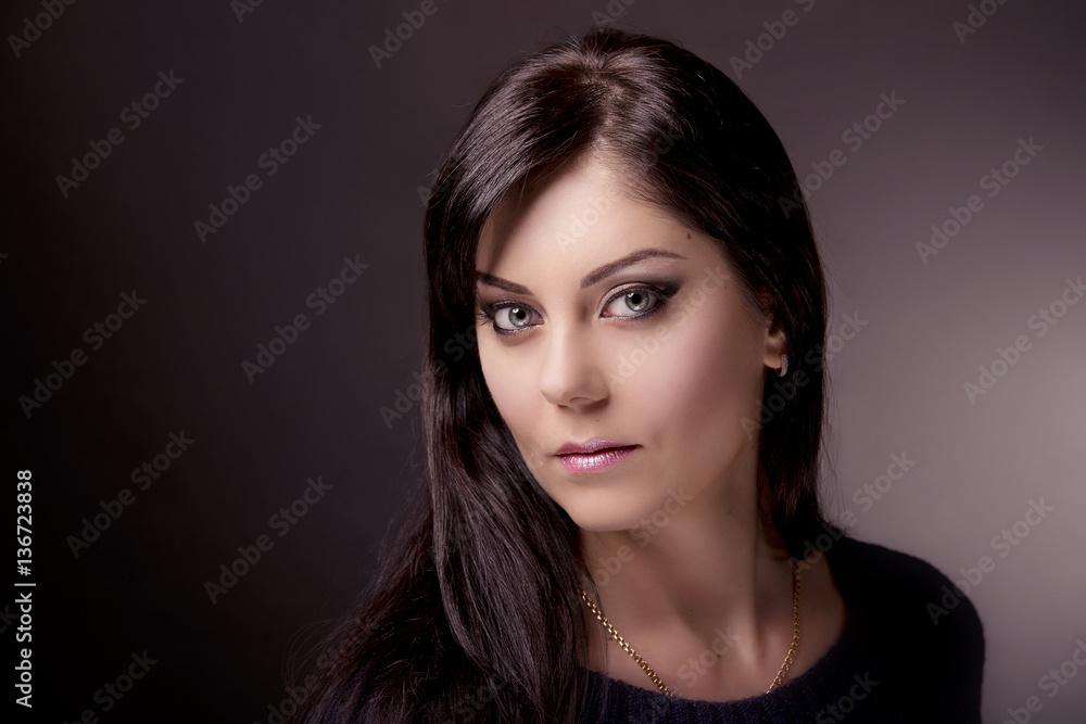 Close-up portrait of brunette with bright makeup on dark background Close-up portrait of brunette with bright makeup on dark background
