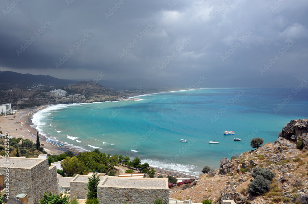 The turquoise water of the sea and the dark clouds, Rhodes, Gree