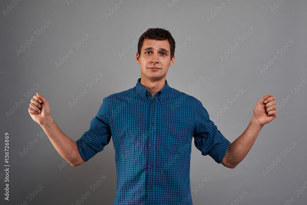 Studio portrait of man with open hands for insert blank banner or product. Quiet emotion on the face. Place for present something. Studio portrait of man with open hands for insert blank banner or product. Quiet emotion on the face. Place for present something.