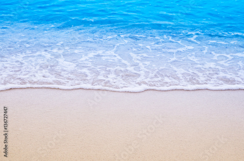 Soft wave of blue ocean on sandy beach. Background. © slonme
