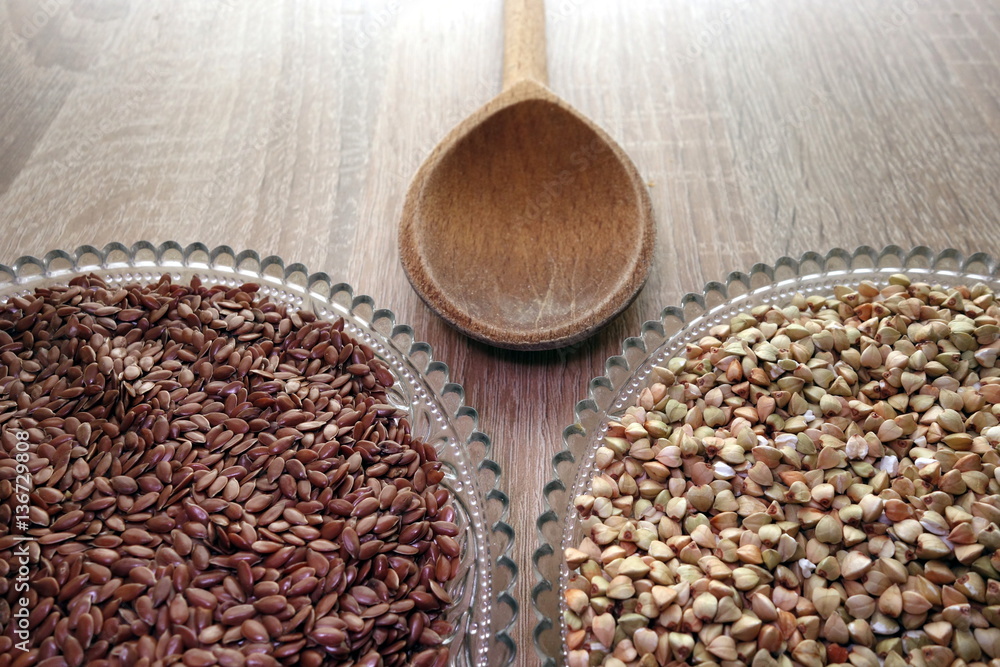 Flax seeds and buckwheat groats on rustic table, healthy diet concept Flax seeds and buckwheat groats on rustic table, healthy diet concept