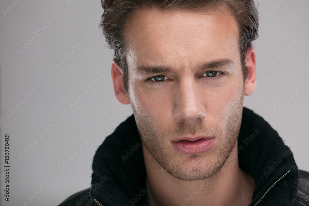 portrait of a young guy over gray background portrait of a young guy over gray background