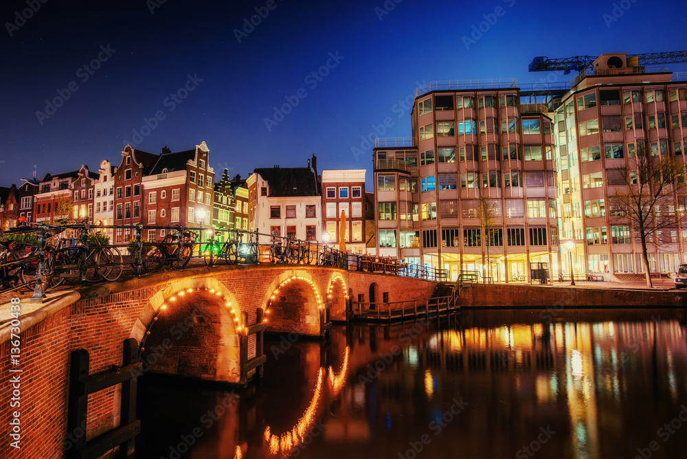 Canal in Amsterdam at night. Highlighting buildings and streets 