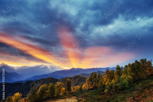 Sunset over snow-capped mountain peaks. © standret