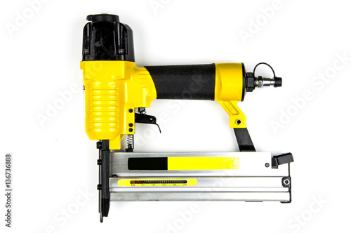 Yellow stapler pneumatic combi on a white background