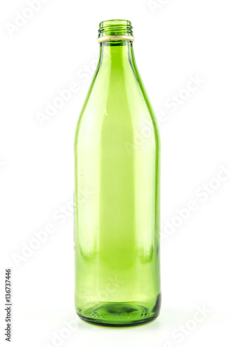 Glass green bottle of mineral water without a lid isolated on a white background