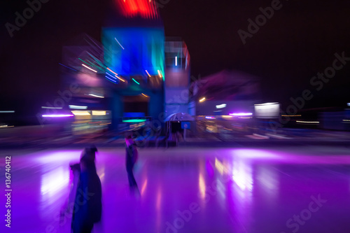 Motion blurred picture of an ice rink with skaters  