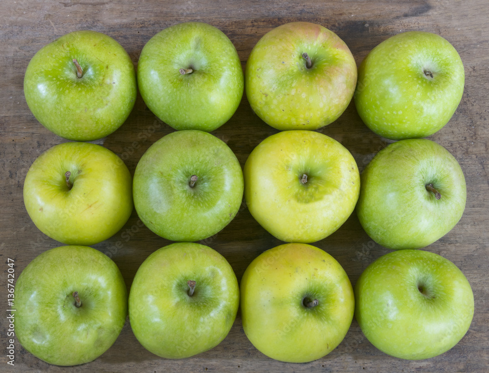 Large group of healthy, green apples on wooden table Large group of healthy, green apples on wooden table