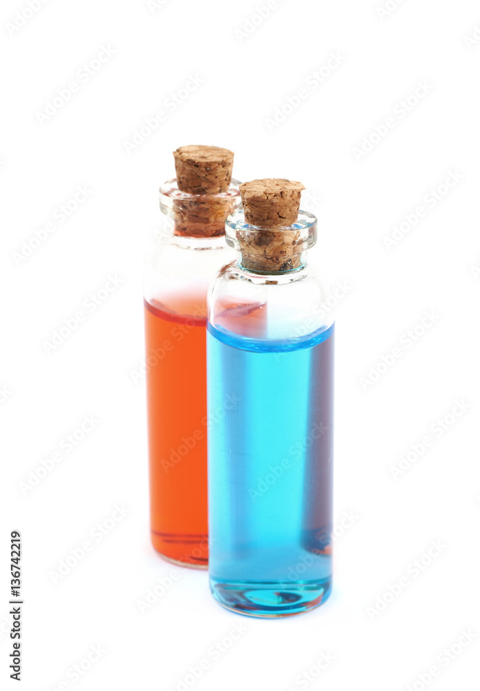Two bottles filled with colored liquid Two bottles filled with colored liquid