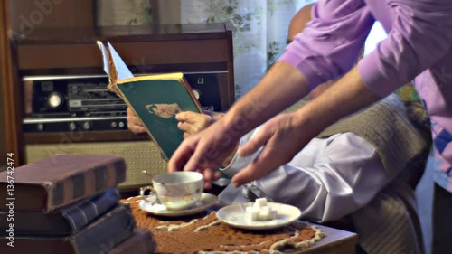 Son Talk to Old Father Which is Reading Old Book Story of Old Man's Life Senior Man Has Some Tea and Enjoys His Memories Pile of Books on the Table