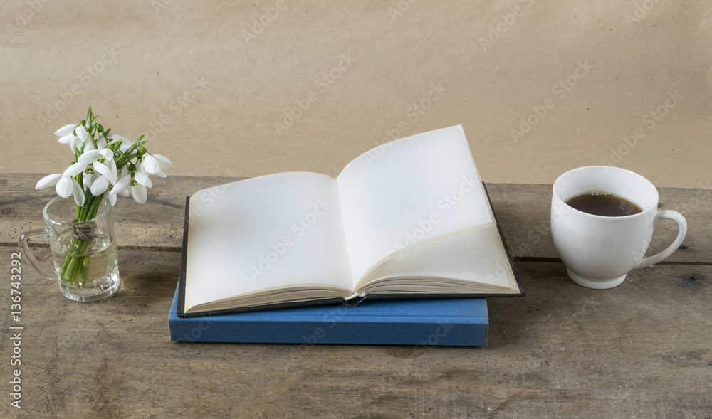Book with empty pages, snowdrops and cup of coffee on wooden table. Book with empty pages, snowdrops and cup of coffee on wooden table.