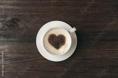 Coffee cup with heart shape on dark background