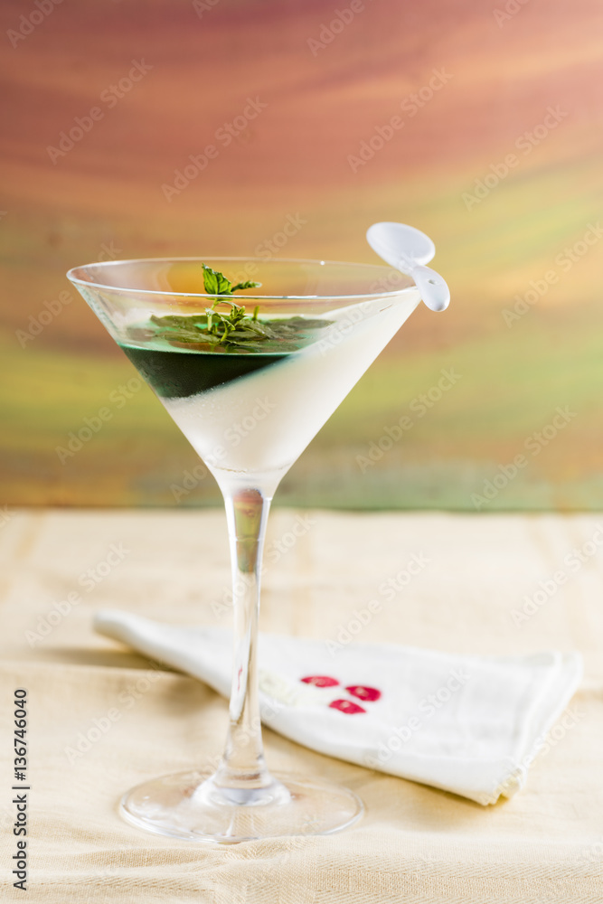 panna cotta with mint syrup and fresh leaves