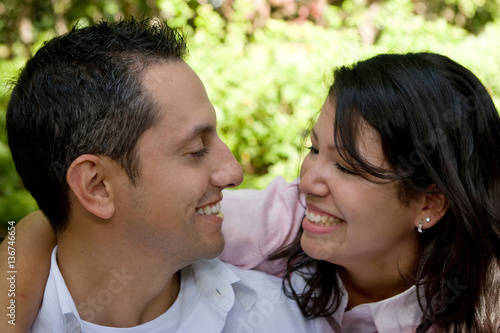 Happy hispanic couple laughing and smiling.
