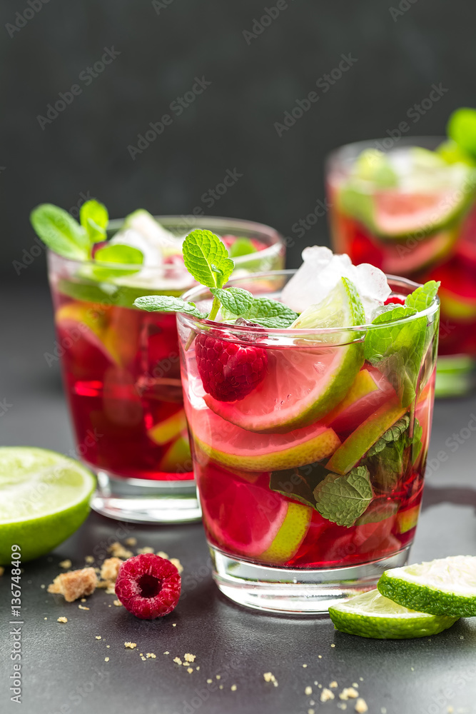 Raspberry mojito cocktail with lime, mint and ice, cold refreshing drink Raspberry mojito cocktail with lime, mint and ice, cold refreshing drink