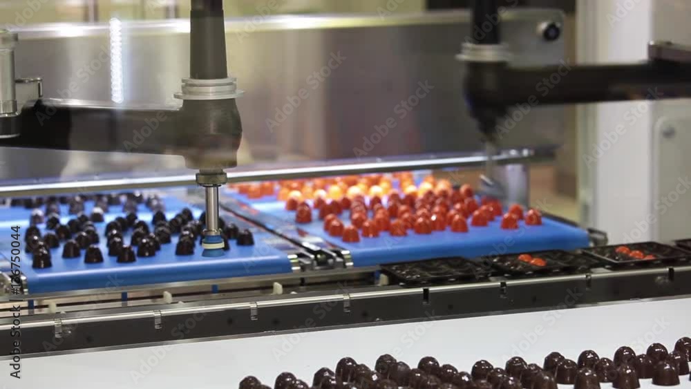 Picker line for chocolate bears, cookies, candies. Close up working process of transporter equipment Picker line for chocolate bears, cookies, candies. Close up working process of transporter equipment
