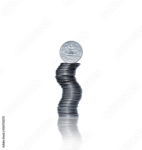 Curved pile of coins with quarter dollar coin on top photo