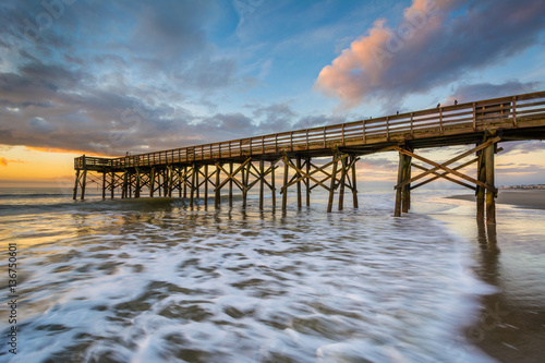 Waves in the Atlantic Ocean and the pier at sunrise  in Isle of