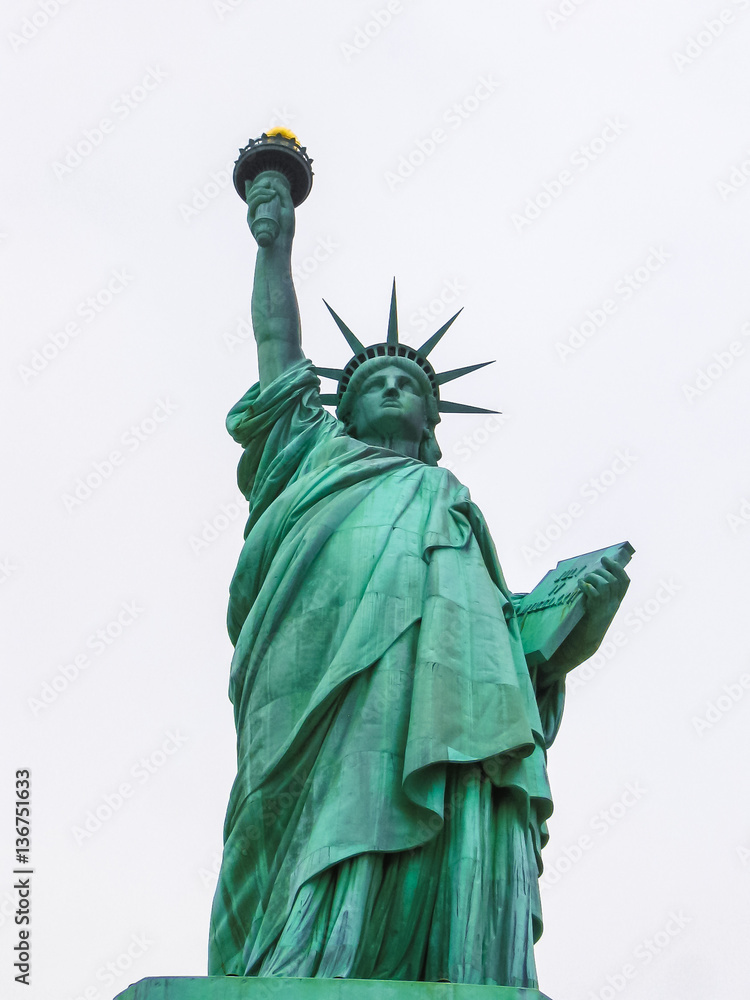 Fototapeta premium Statue of liberty on a cloudy white sky, New York, Bay of Manhattan, United States of America, view from front side