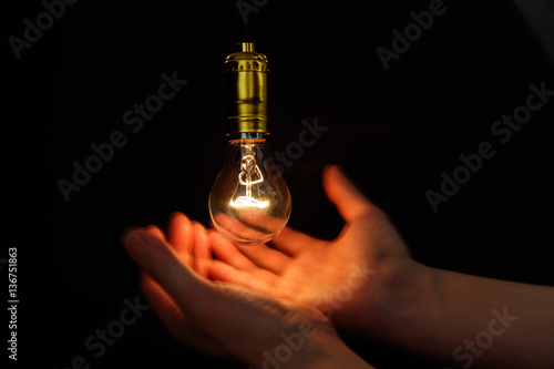 Light bulb and hand