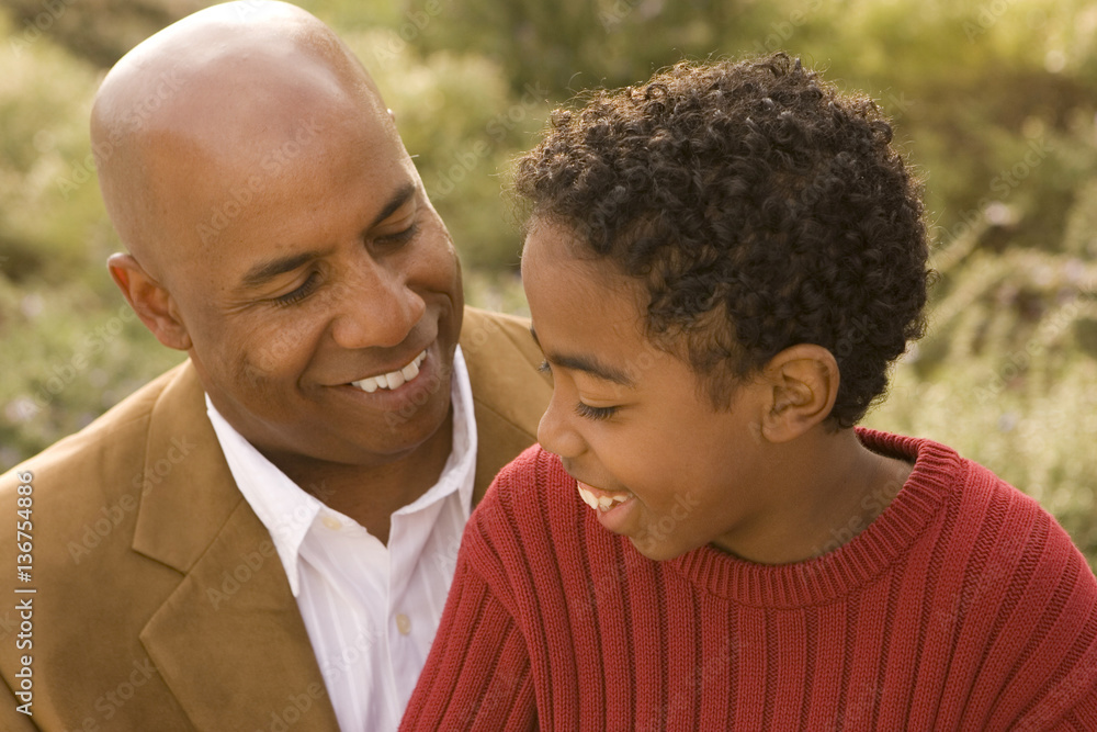 Fototapeta premium African American father and son talking and laughing.