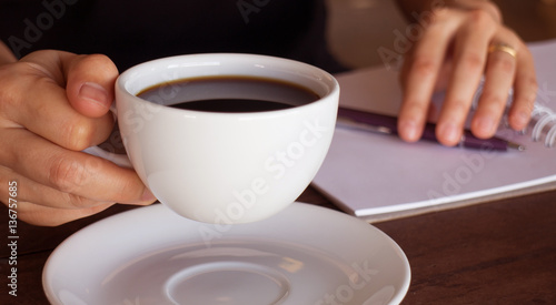 Hot cup of coffee on working table