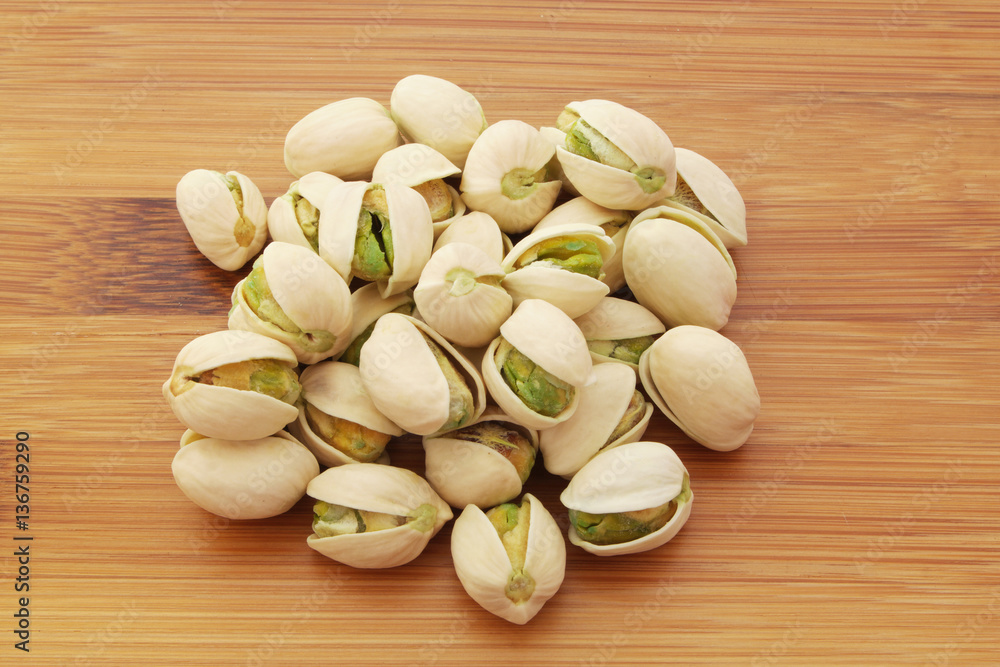 Pistachio nuts on wooden background Pistachio nuts on wooden background