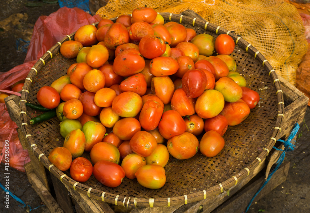Red tomatoes on a bamboo basket photo taken in Bogor Indonesia