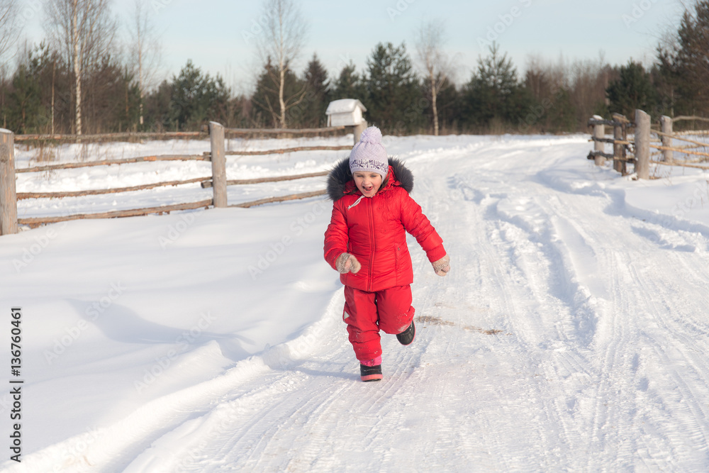 cheerful girl running in winter