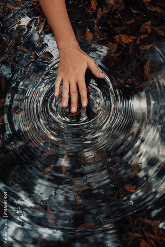 woman hand making circles on water
