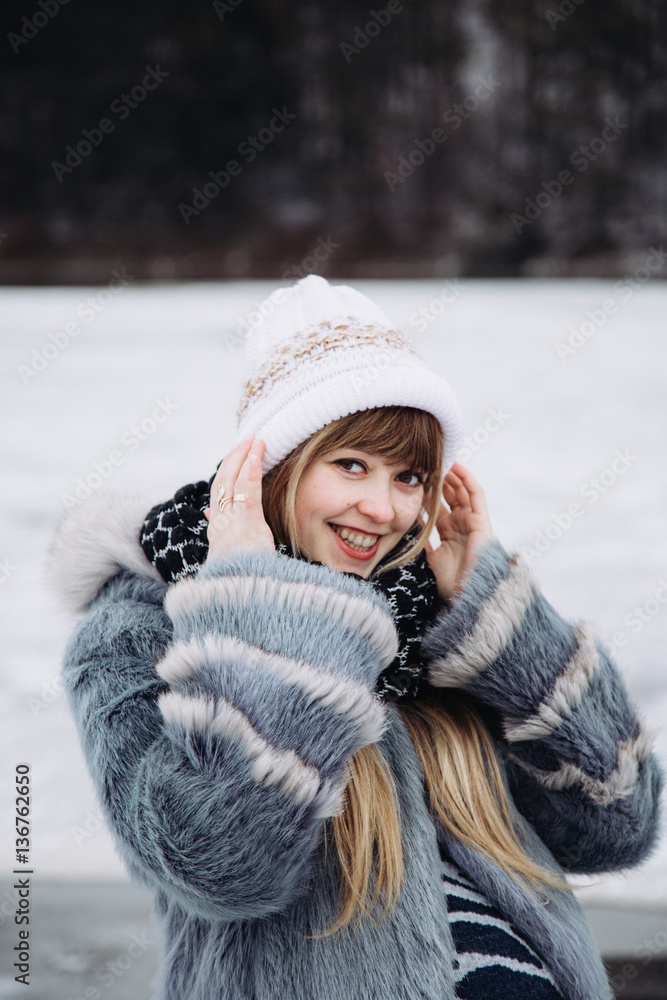 Cute pregnant girl in a fur coat outdoors Cute pregnant girl in a fur coat outdoors
