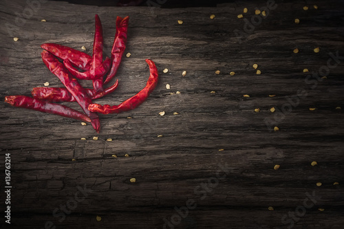 Dried red chili peppers on wooden background