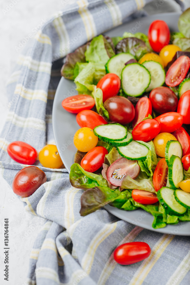 Healthy homemade salad of red and yellow cherry tomato and herbs on the table close up Healthy homemade salad of red and yellow cherry tomato and herbs on the table close up