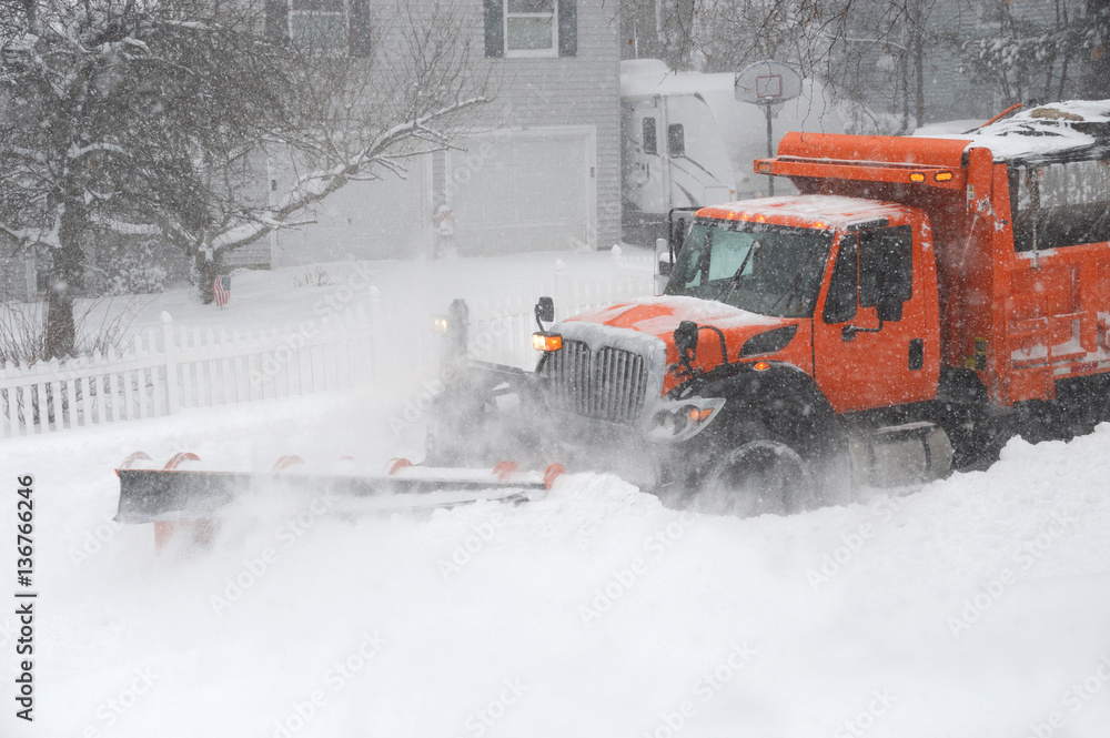 snowplow truck removing snow on the street after blizzard snowplow truck removing snow on the street after blizzard