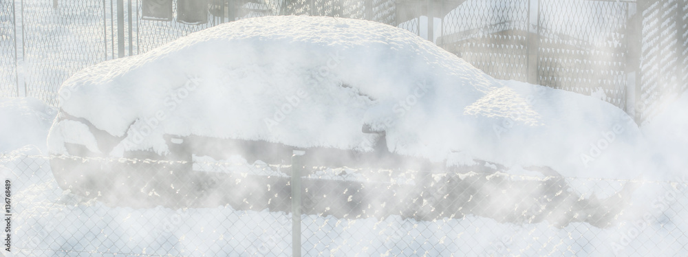 Snow covered car in the fog behind the fence. Snow covered car in the fog behind the fence.