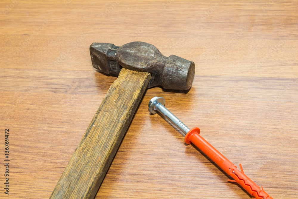 plastic dowel and hammer on wooden background