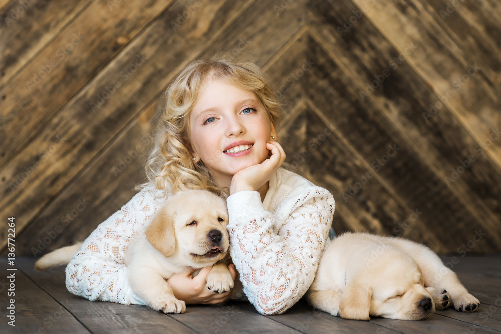 Little girl with a labrador puppies Little girl with a labrador puppies