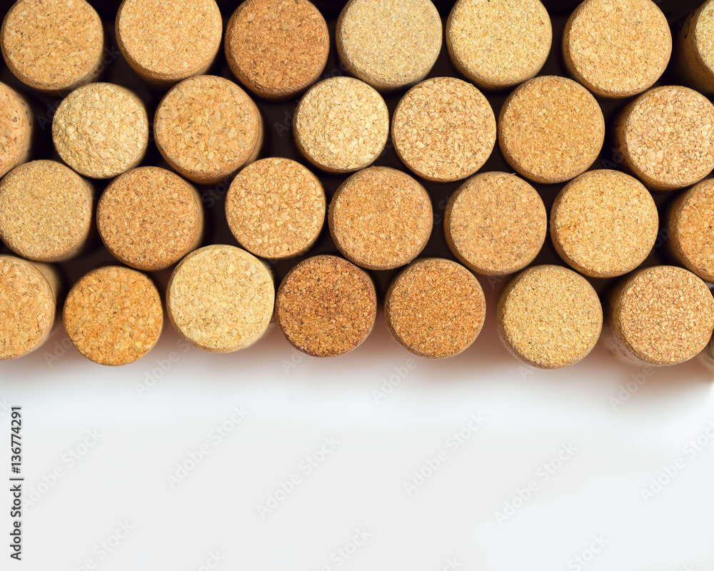 . Wine corks on light paper background for your text. Yellow beige color of cork lying in a row and copy space. . Wine corks on light paper background for your text. Yellow beige color of cork lying in a row and copy space.