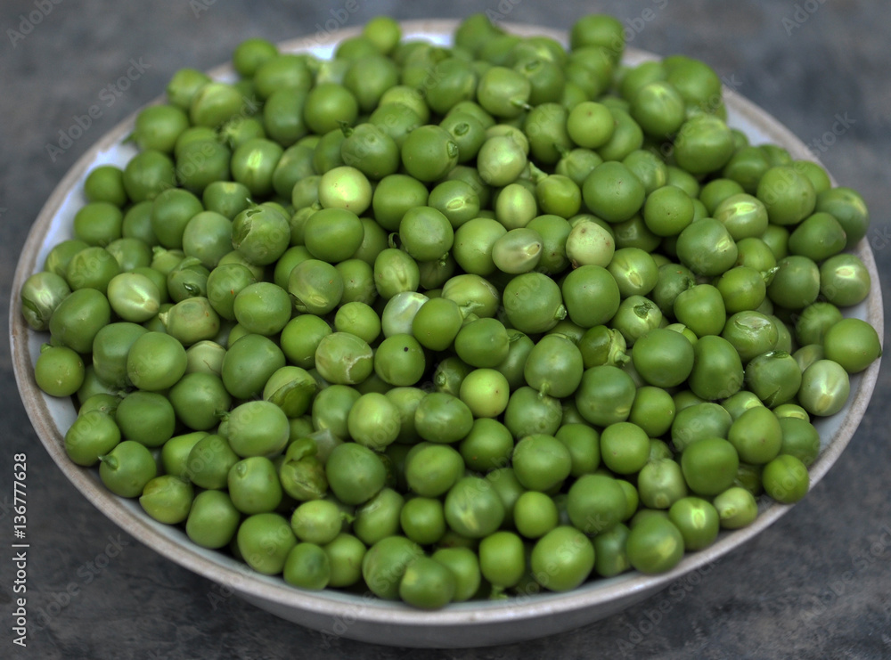 Nuts young pea seeds, green, peeled embankment in white plate Nuts young pea seeds, green, peeled embankment in white plate
