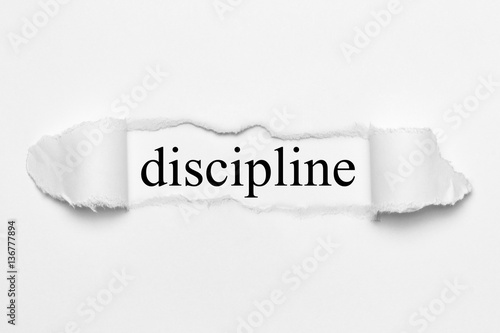 discipline on white torn paper photo