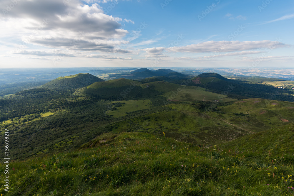 Fototapeta premium Vue en altitude des volcans du Puy de Dôme en Auvergne France. Magnifique ciel bleu et paysage verdoyant.
