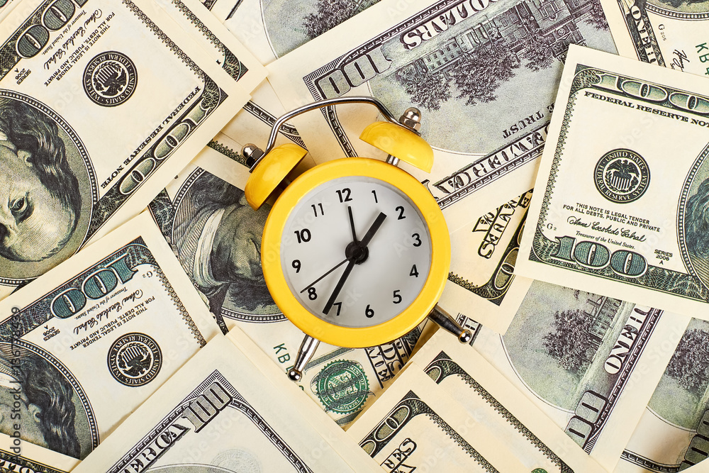 Alarm clock and dollars. Time is money. Alarm clock and dollars. Time is money.