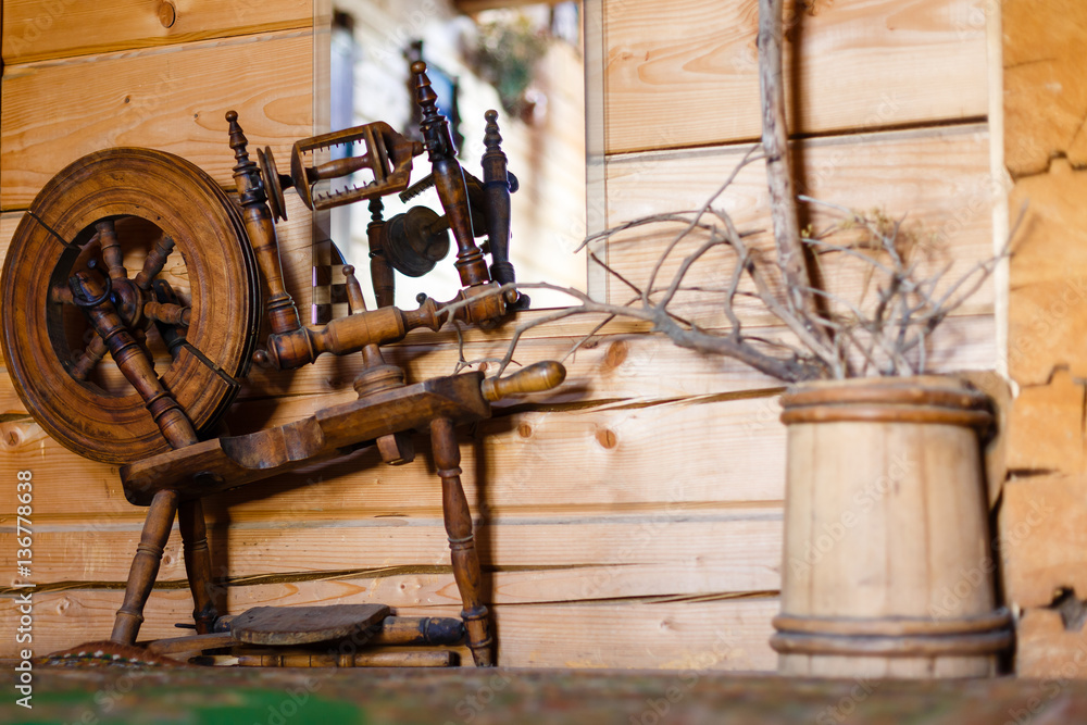 Traditional devices, vintage tailoring equipment concept. Old fashioned wooden distaff, spindle, spinning wheel