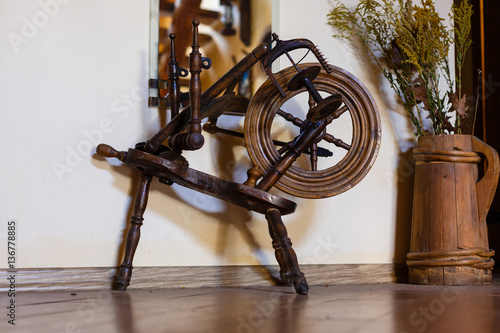 Traditional devices, vintage tailoring equipment concept. Old fashioned wooden distaff, spindle, spinning wheel